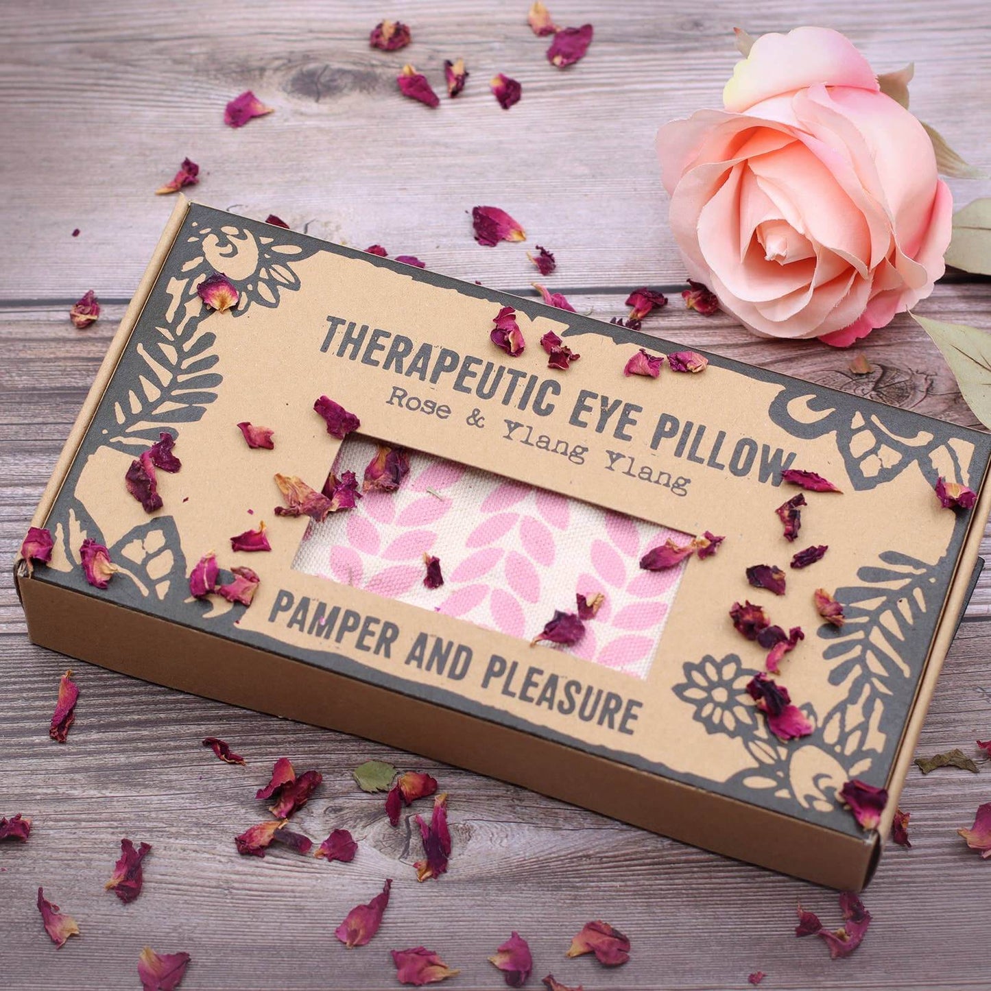 Brown box with window showing product on a wood background with petals