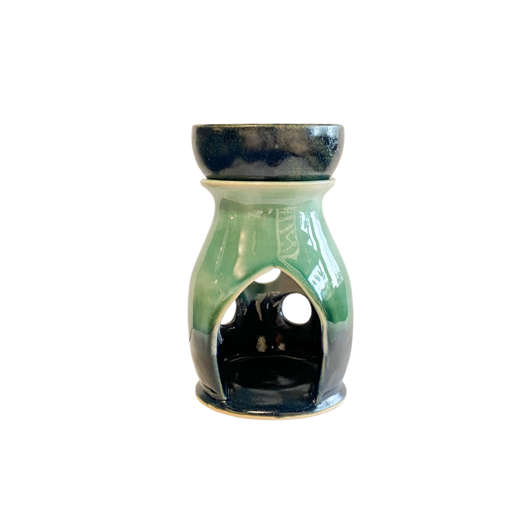 Hand thrown stoneware wax burner in blue and green glaze with Celtic design accents back view