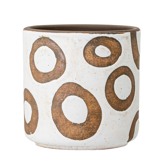 Ceramic pot with brown circular patterns on a white background