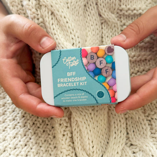 Cotton Tales BFF Friendship Bracelet Kit held by hands on a knitted background