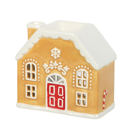 Decorative gingerbread house oil burner with a red door on a white background
