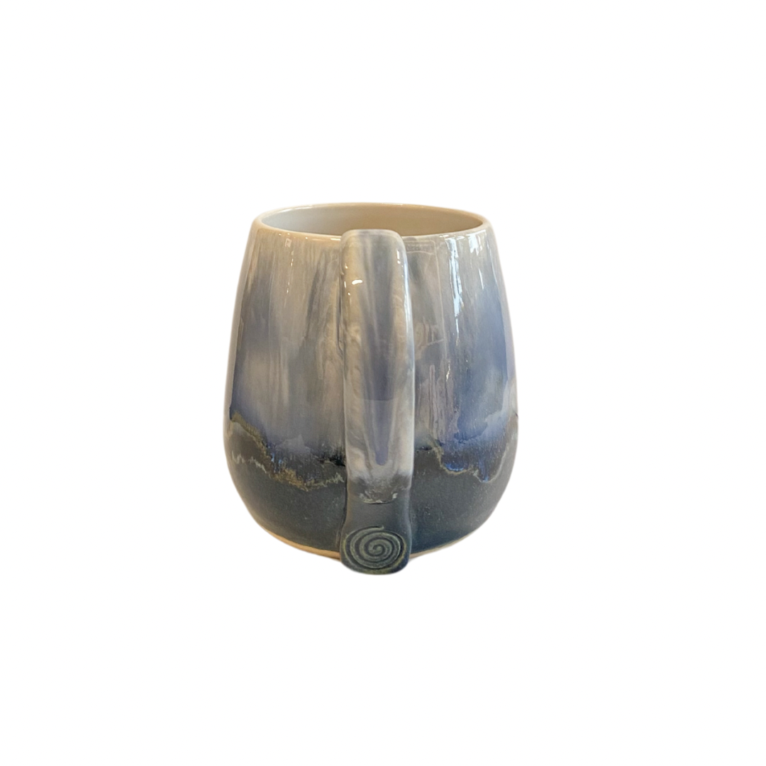 Blue ombre glazed mug. Image showing the Celtic swirl design imprinted at the base of the handle