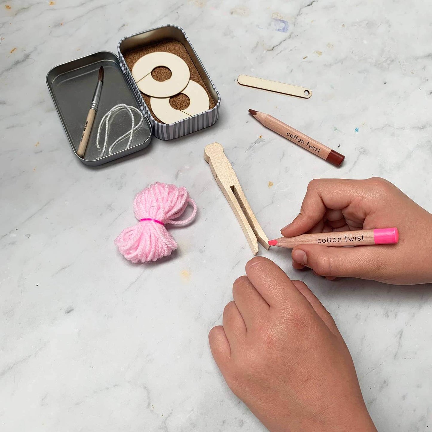 Child making a Pom Pom Ballerina Peg Doll-Make Your Own contents