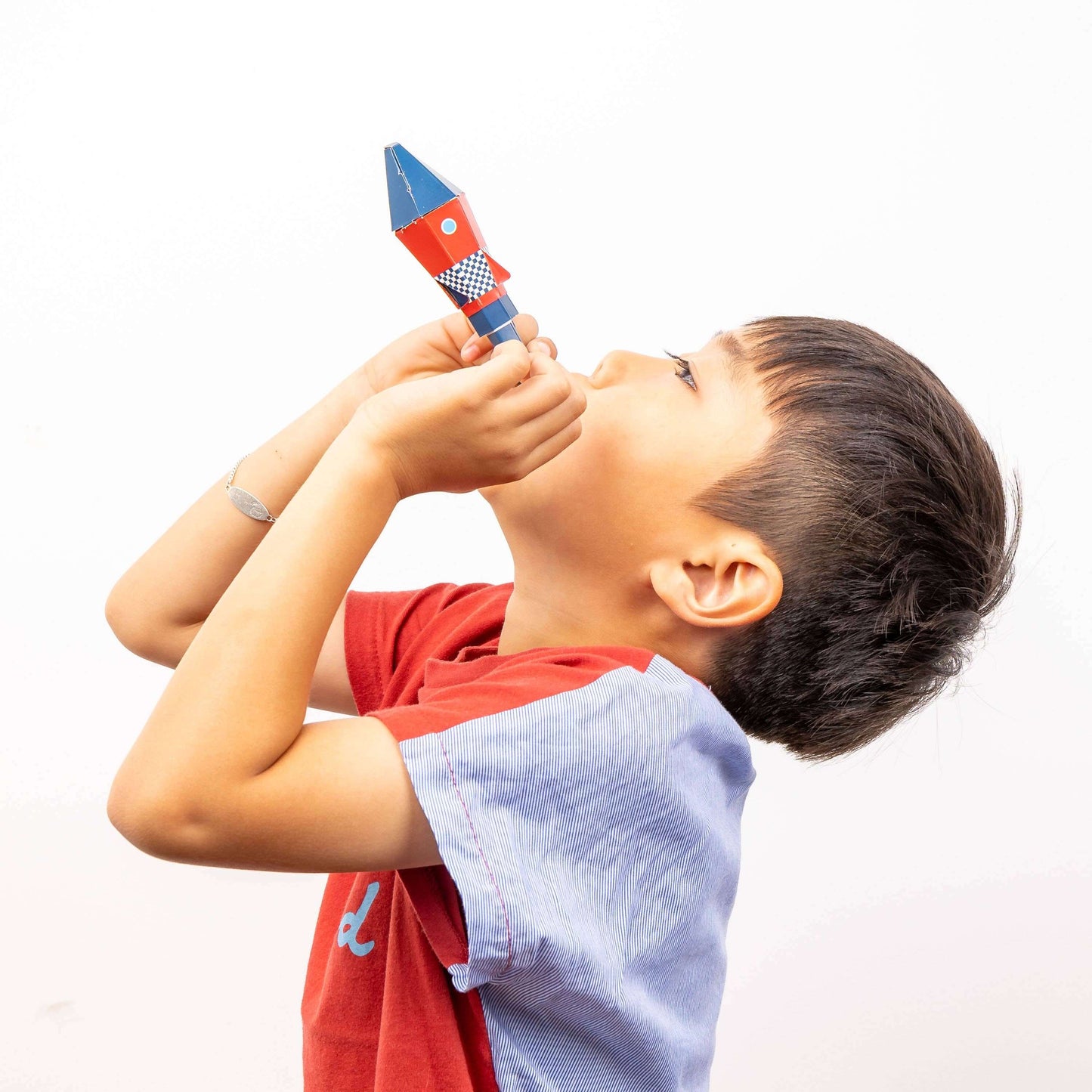 Child playing with colorful toy rocket with