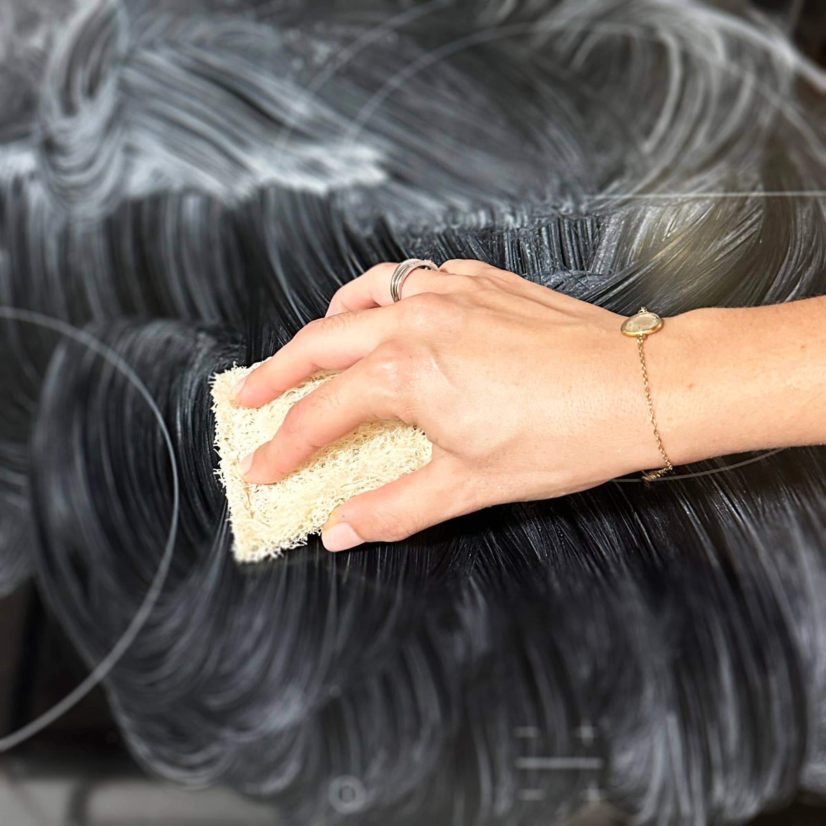 Hand used a cleaner on an oven door