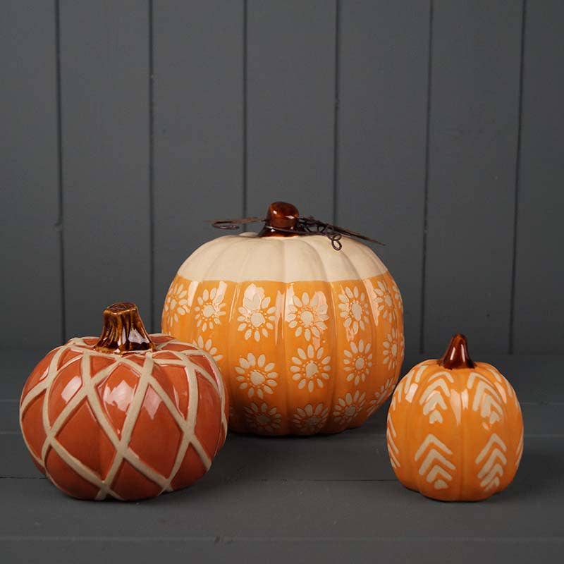 three different sized ceramic pumpkins