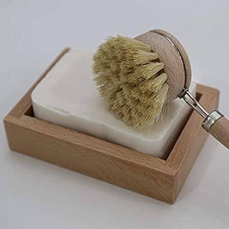 Lemon scented Eco Dish Soap Bar on wooden soap dish with a wooden dish scrubbing brush