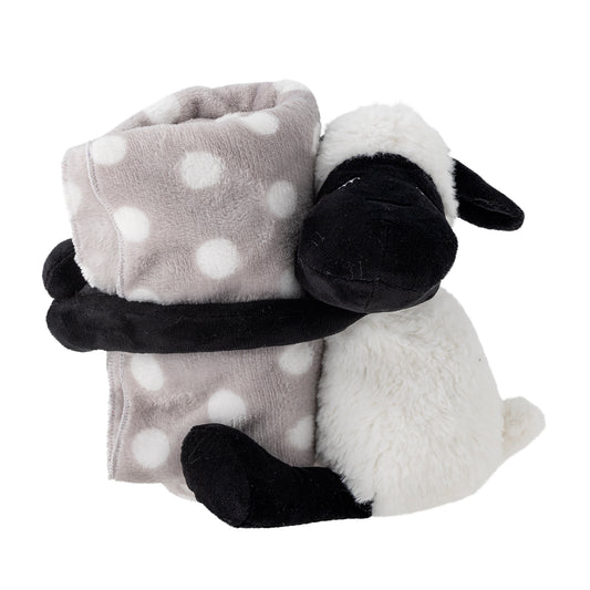 A soft toy sheep with a detachable gray and white dotted blanket attached to its hands.