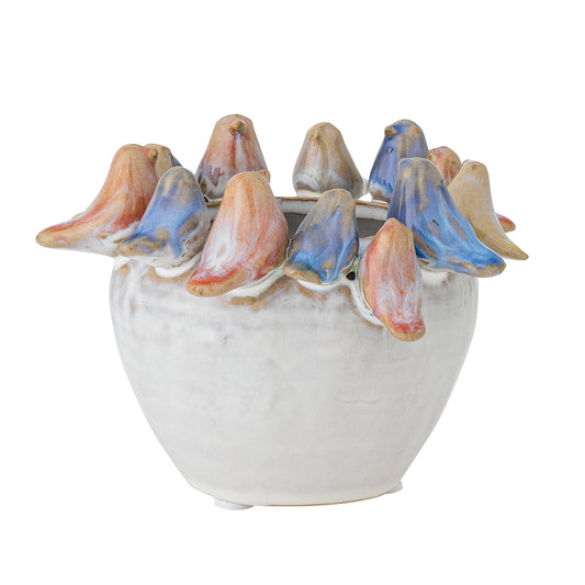 A small ceramic flowerpot with a grey exterior and multicolored bird details around the rim.