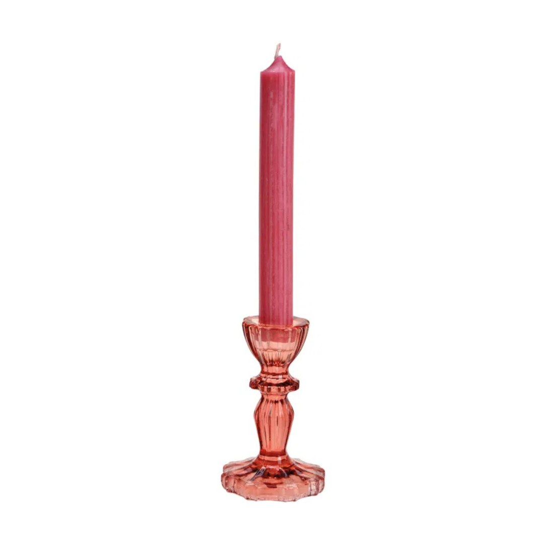 Pink candle in a decorative holder on a white background