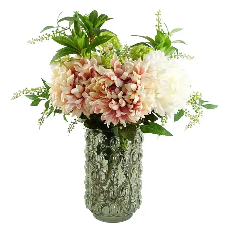 A green retro style glass vase with an embossed bubble pattern filled with flowers on a white background