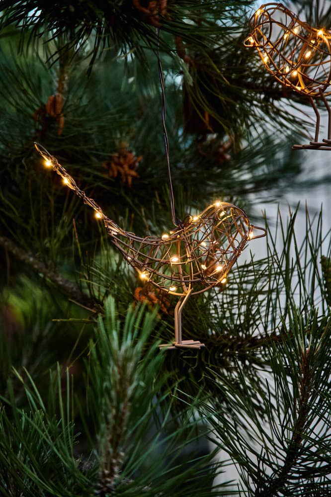 Decorative bird lights hanging on a Christmas tree
