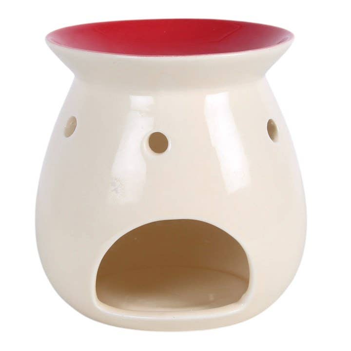 White ceramic oil burner with a red top on a white background