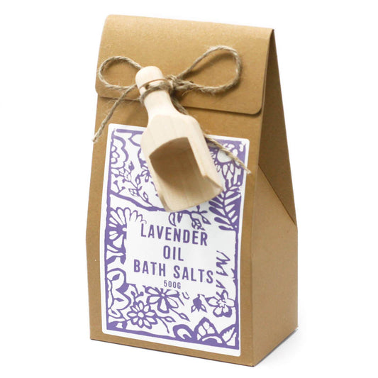 A package of Himalayan lavender oil bath salts with a wooden scoop and a floral design on the packaging.