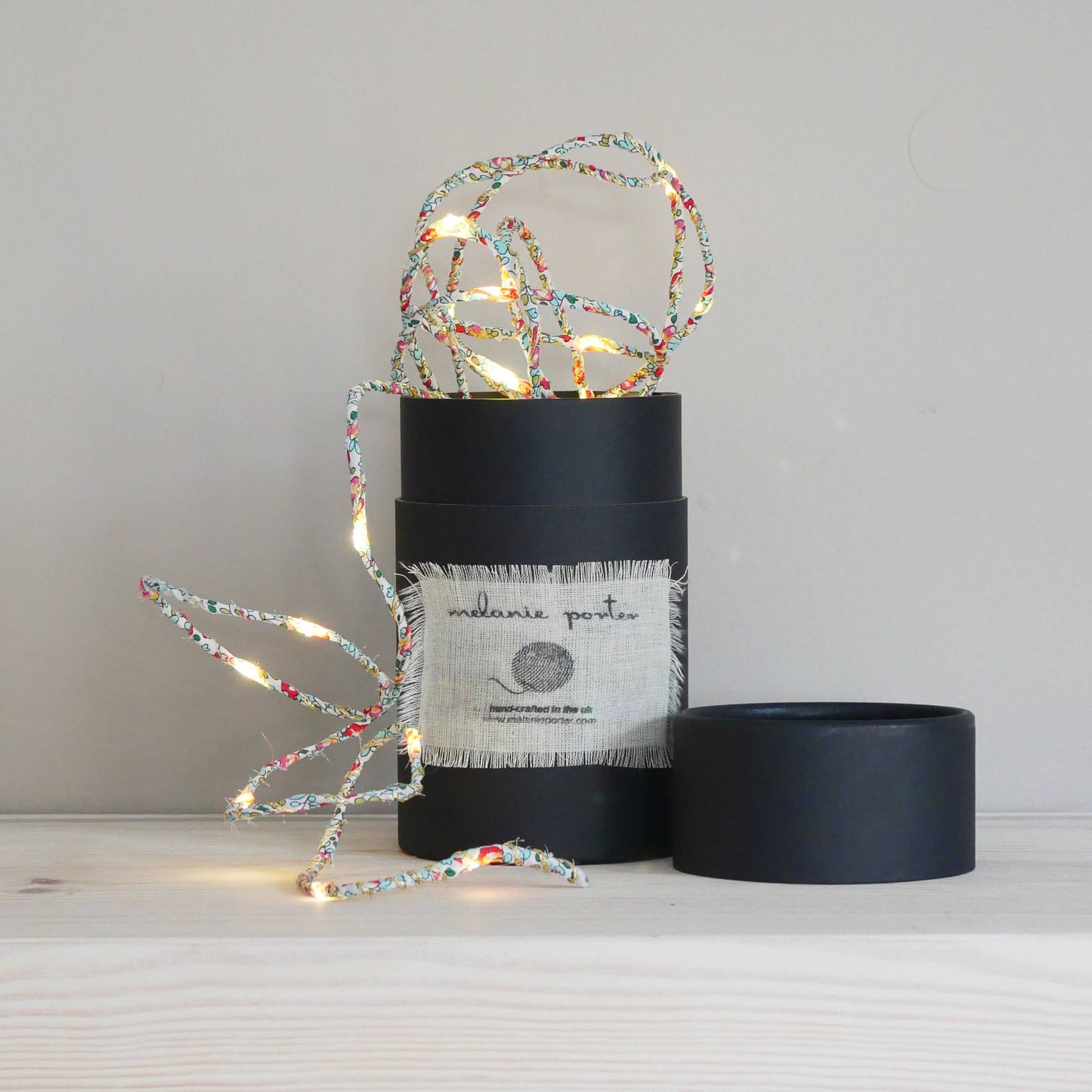 Liberty Print Fairy Light String: Eloise. String of fabric covered fairy lights in a black cylinder container