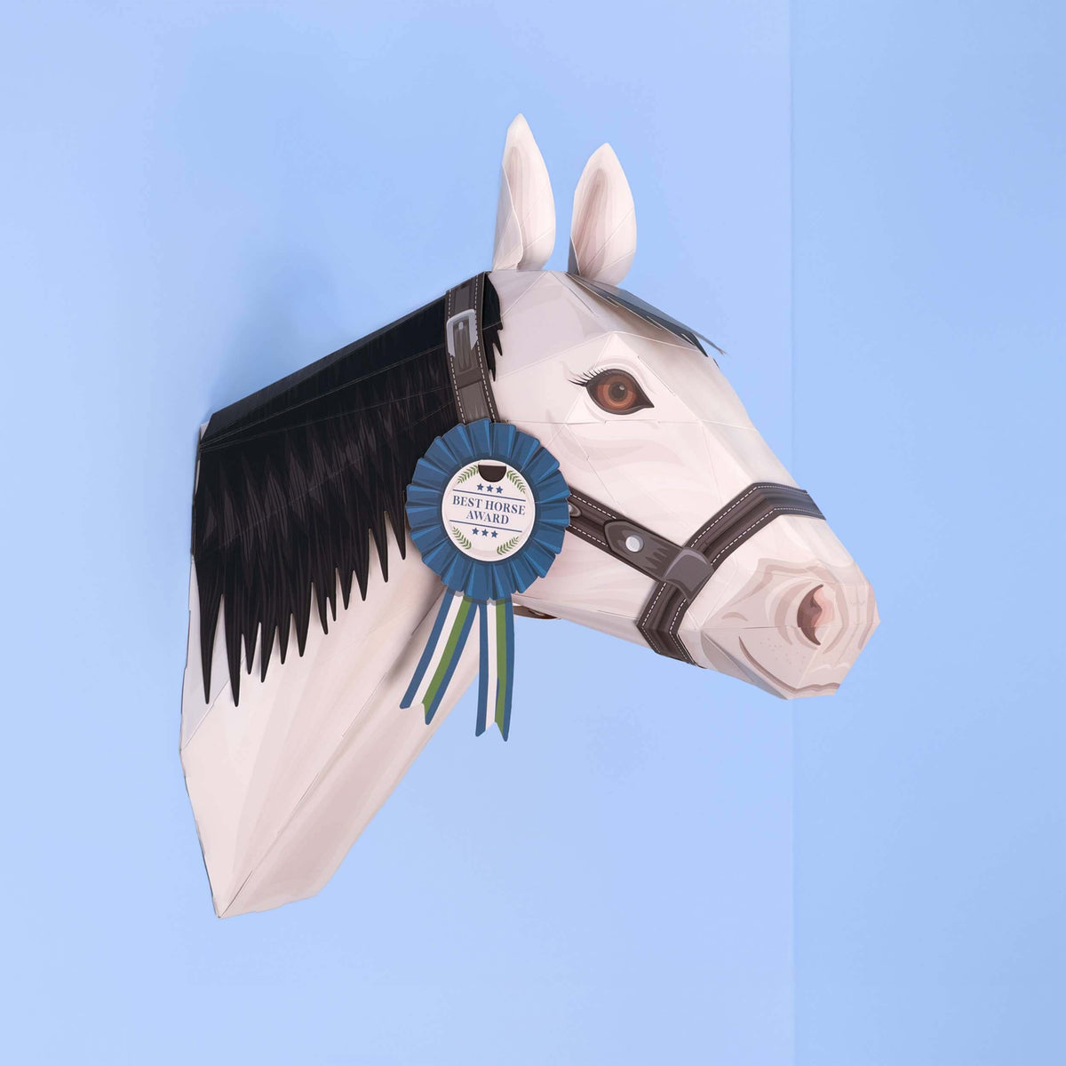 Horse head paper sculpture with a ribbon on a blue background