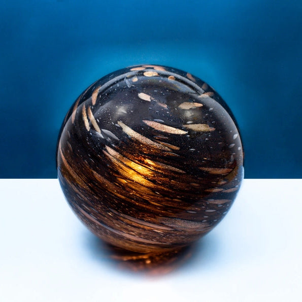 Decorative sphere lamp with intricate patterns on a blue and white background