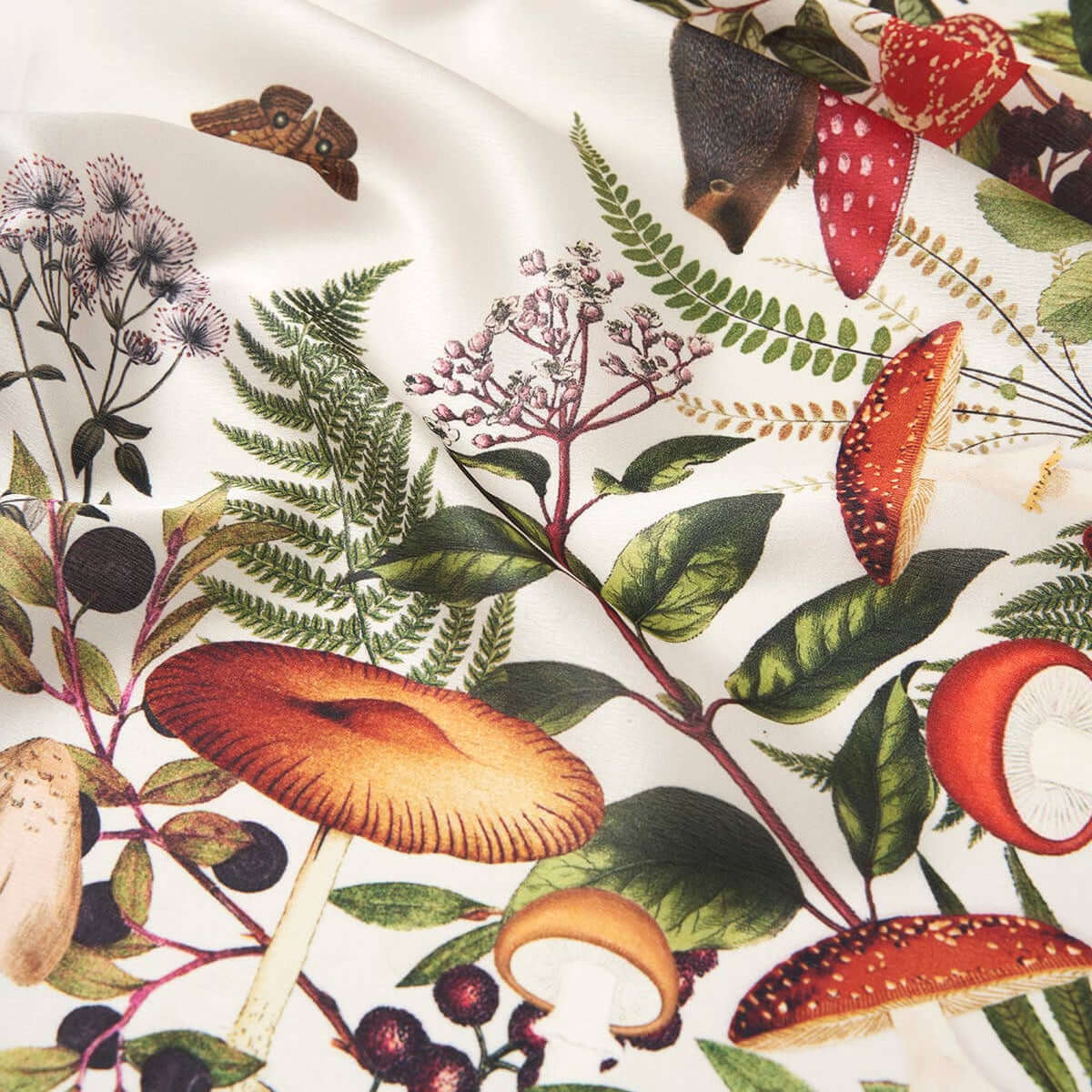 Scarf with a colorful pattern of mushrooms, leaves, and berries on a white background