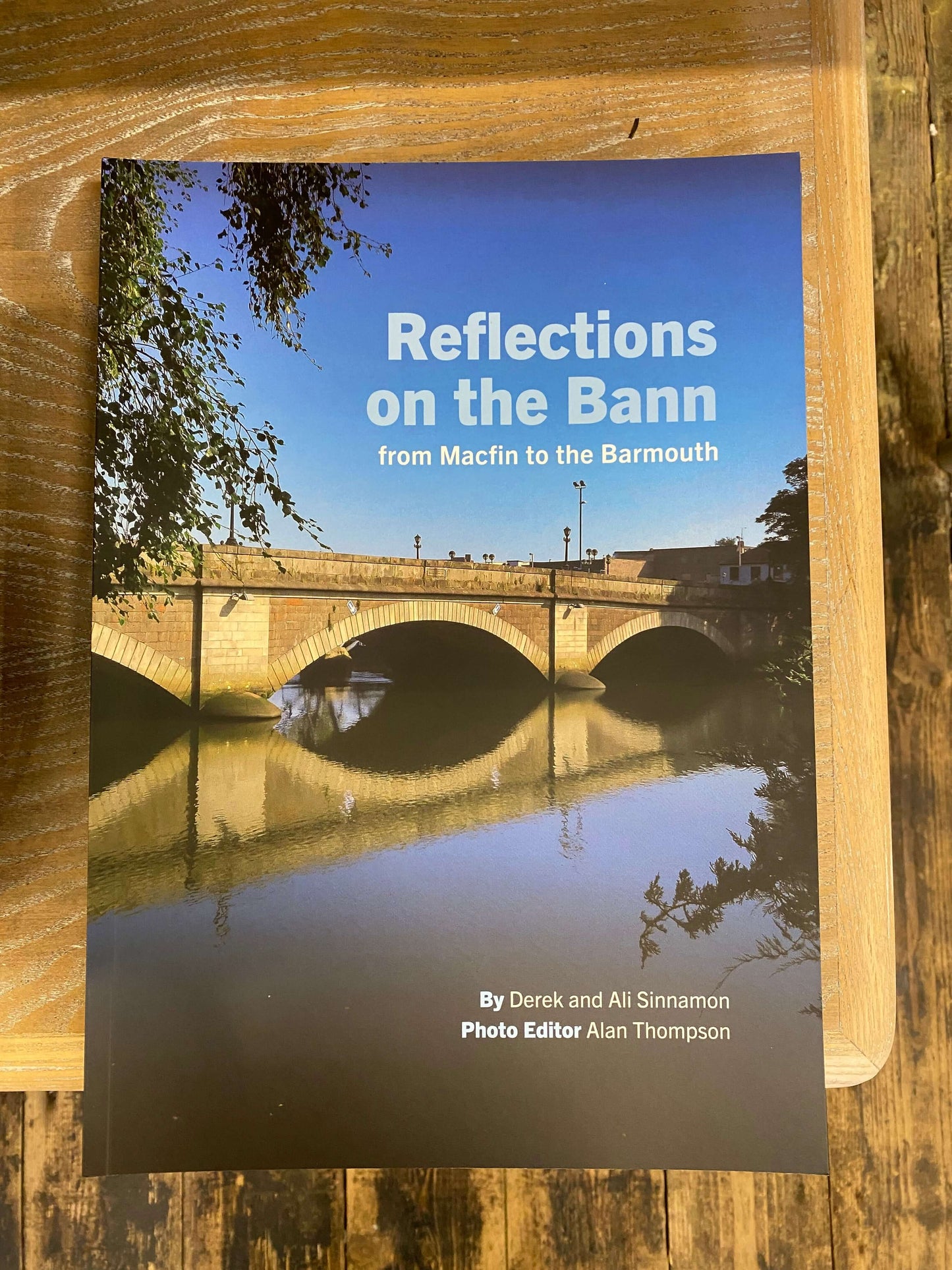 Book titled 'Reflections on the Barrn' on a wooden surface