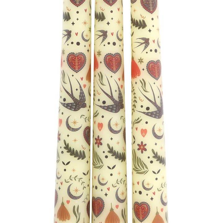Three candles with decorative patterns on a white background