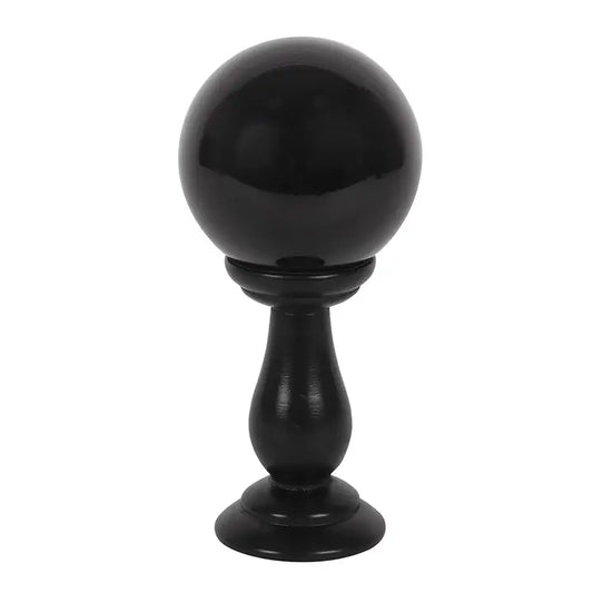 Black spherical object on a stand against a white background