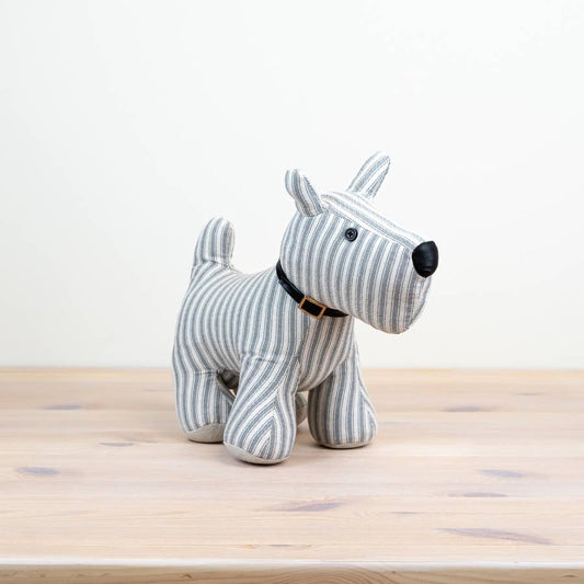 A fabric dog doorstop with a striped pattern and a cute collar, displayed on a wooden floor against a white background.