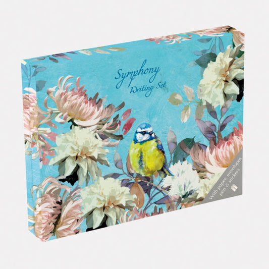 Writing set packaging with floral design and bird illustration on a blue background