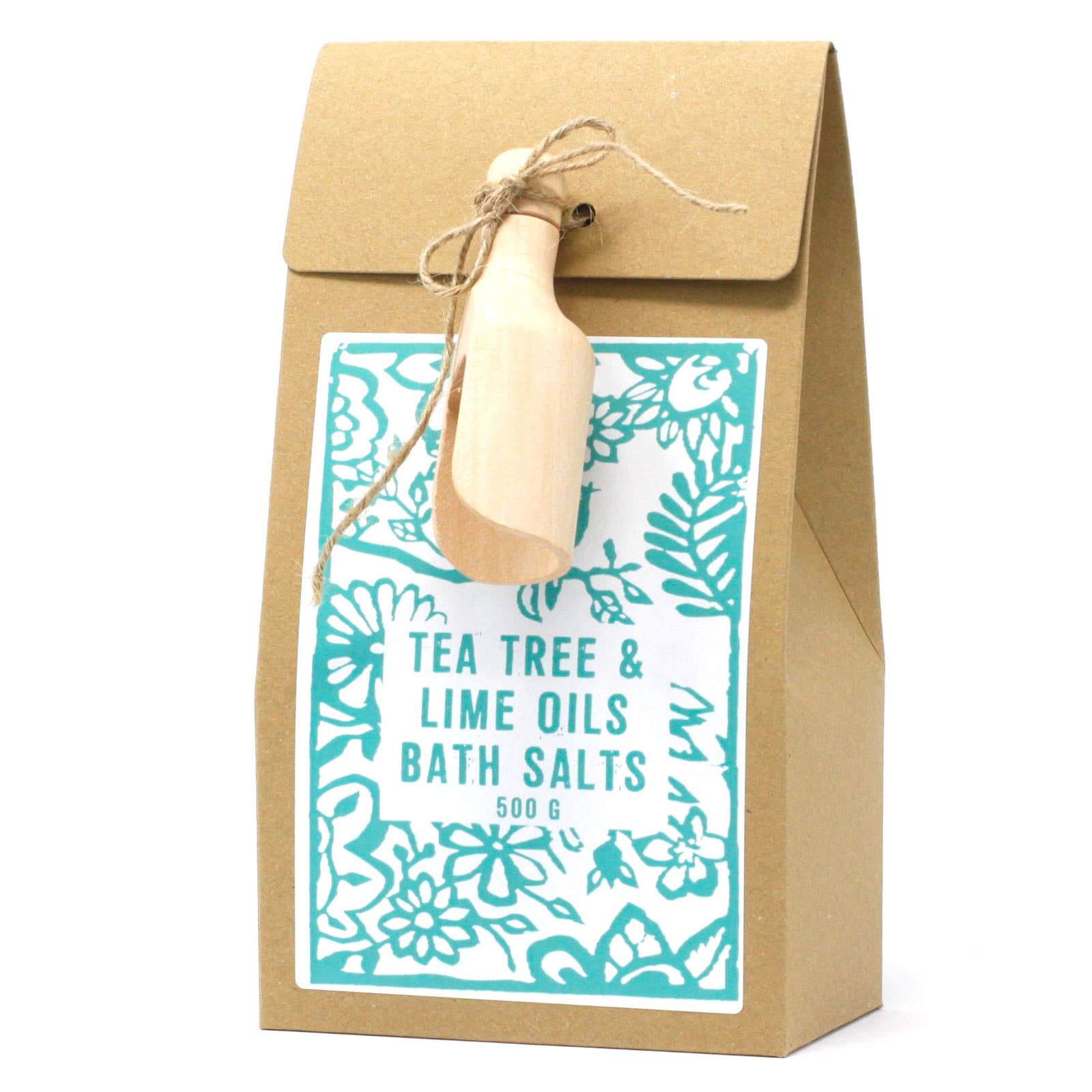 A package of Himalayan Tea Tree & Lime Oils Bath Salts with a wooden scoop attached to the top, presented in a brown paper bag with a floral pattern and a kraft label.