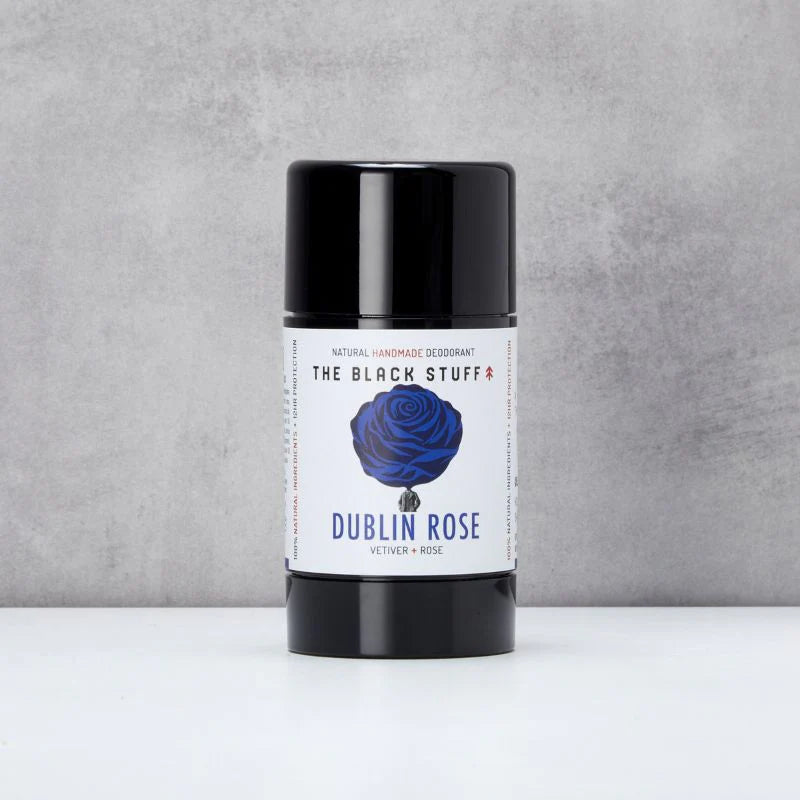 Deodorant stick labeled 'Dublin Rose' by 'The Black Stuff' on a gray background