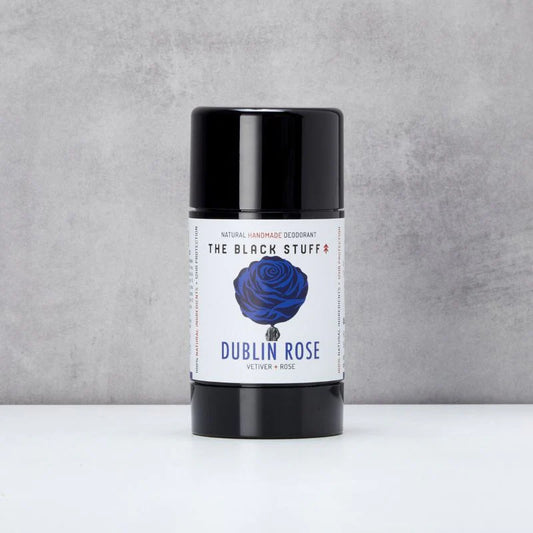 Deodorant stick labeled 'Dublin Rose' by 'The Black Stuff' on a gray background