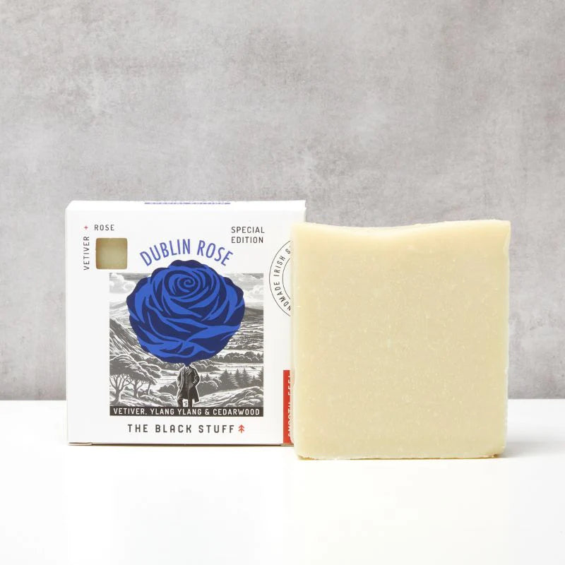 Bar of The Black Stuff Dublin Rose soap unboxed sitting beside packaging labeled 'Dublin Rose' on a gray background