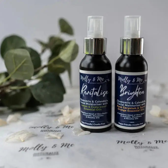 Two bottles of Molly & Me skincare products on a light surface with greenery in the background.