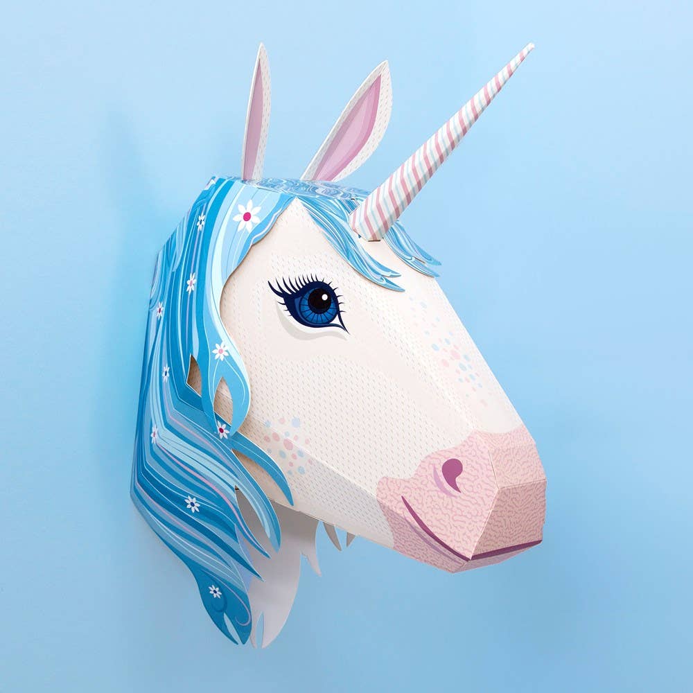 Unicorn head decoration with blue hair and pink nose on a light blue background