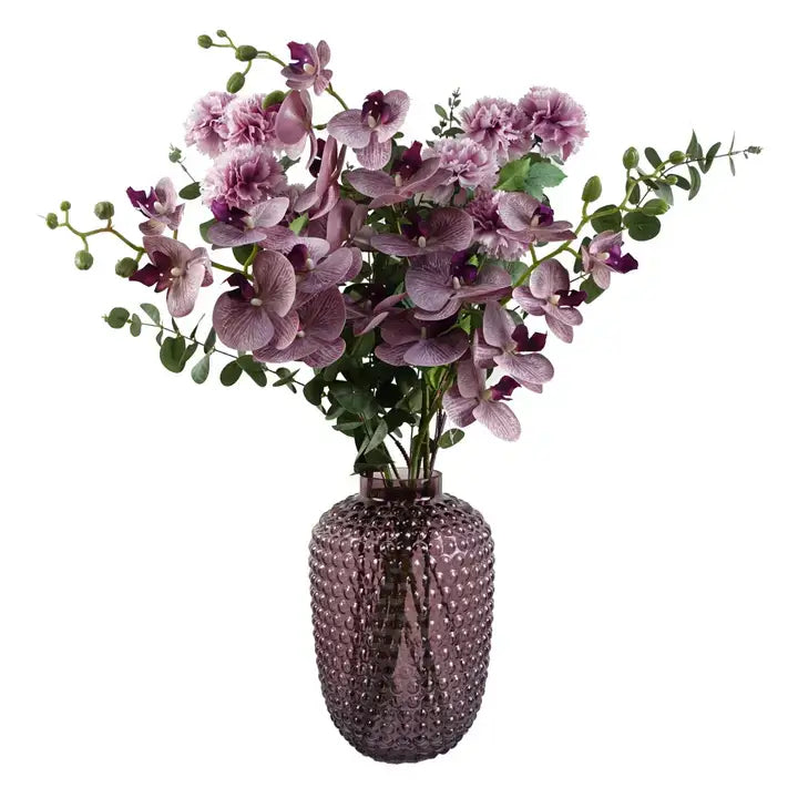 A glass mulberry coloured bubble vase with purple flowers on a white background