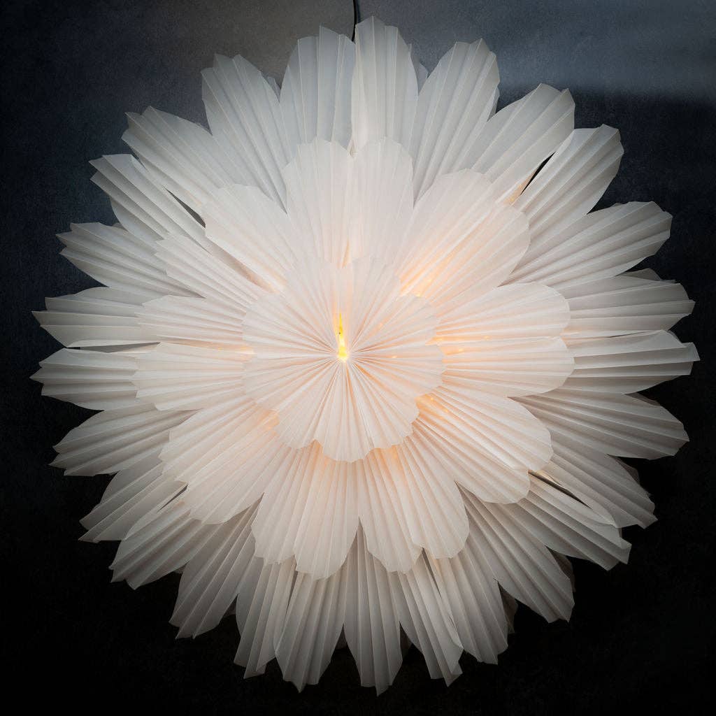 A large white paper wall hanging decoration with a flower-like design, liights inside. intended to be used as a decorative piece on walls.