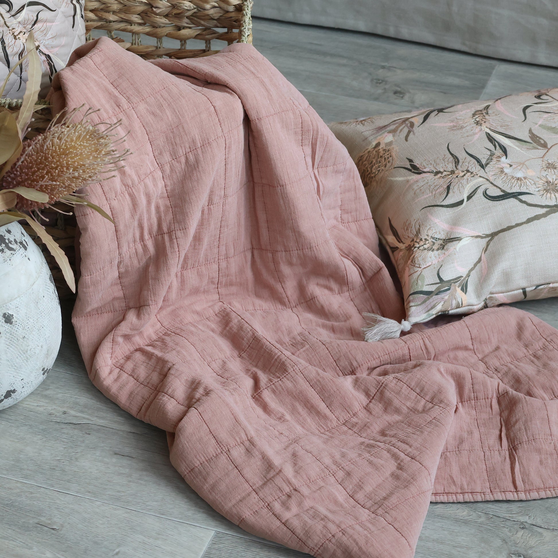 Dusky pink taupe quilt draped over a chair