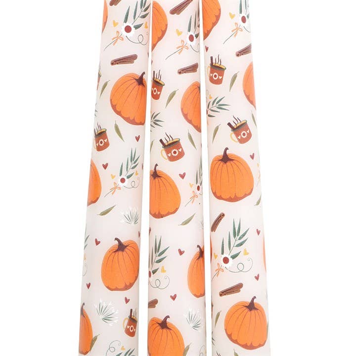Set of 3 Autumn pumpkin patterned taper candles. A close up shot