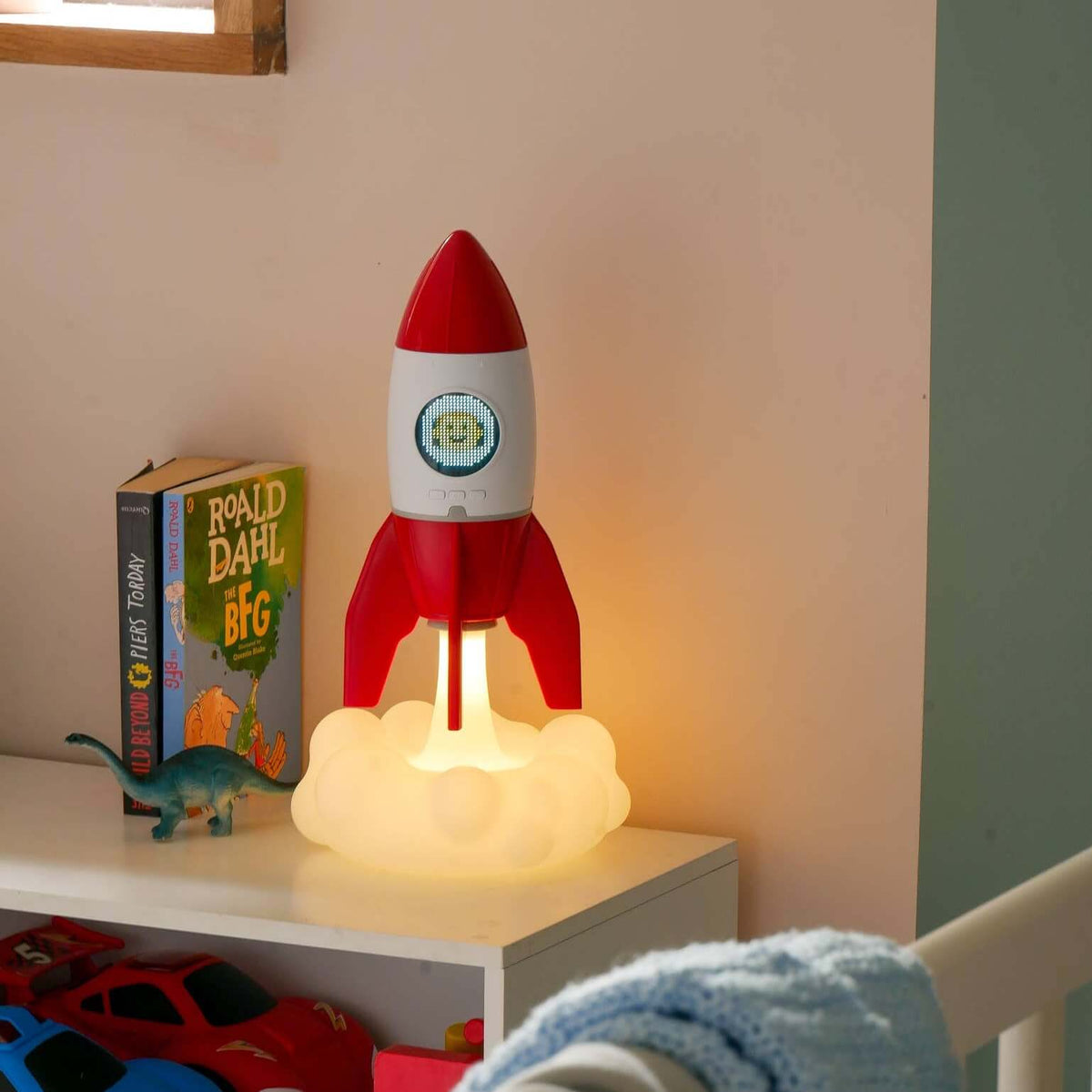 Rocket 3-in-1 bedside light glowing on a nightstand