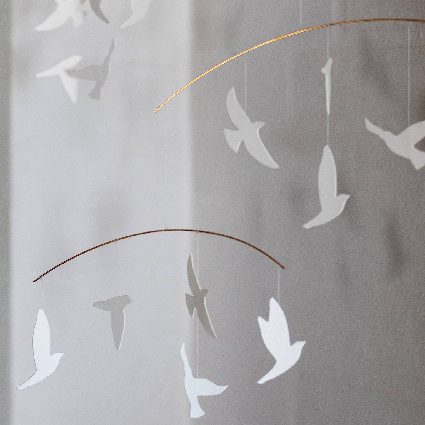 Decorative wall art of white birds on a white wall Close up view