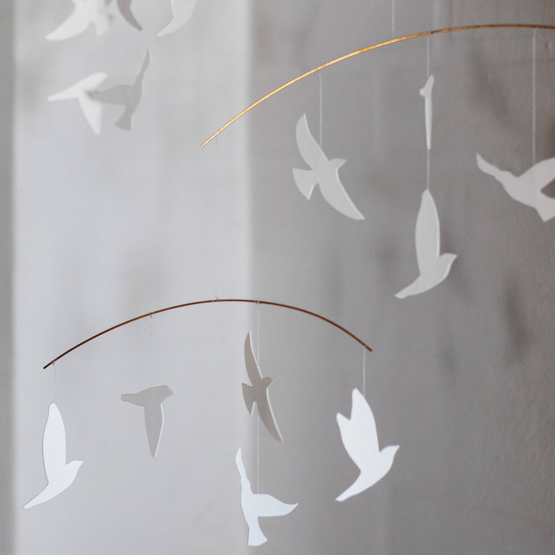 Decorative wall art of white birds on a white wall Close up view