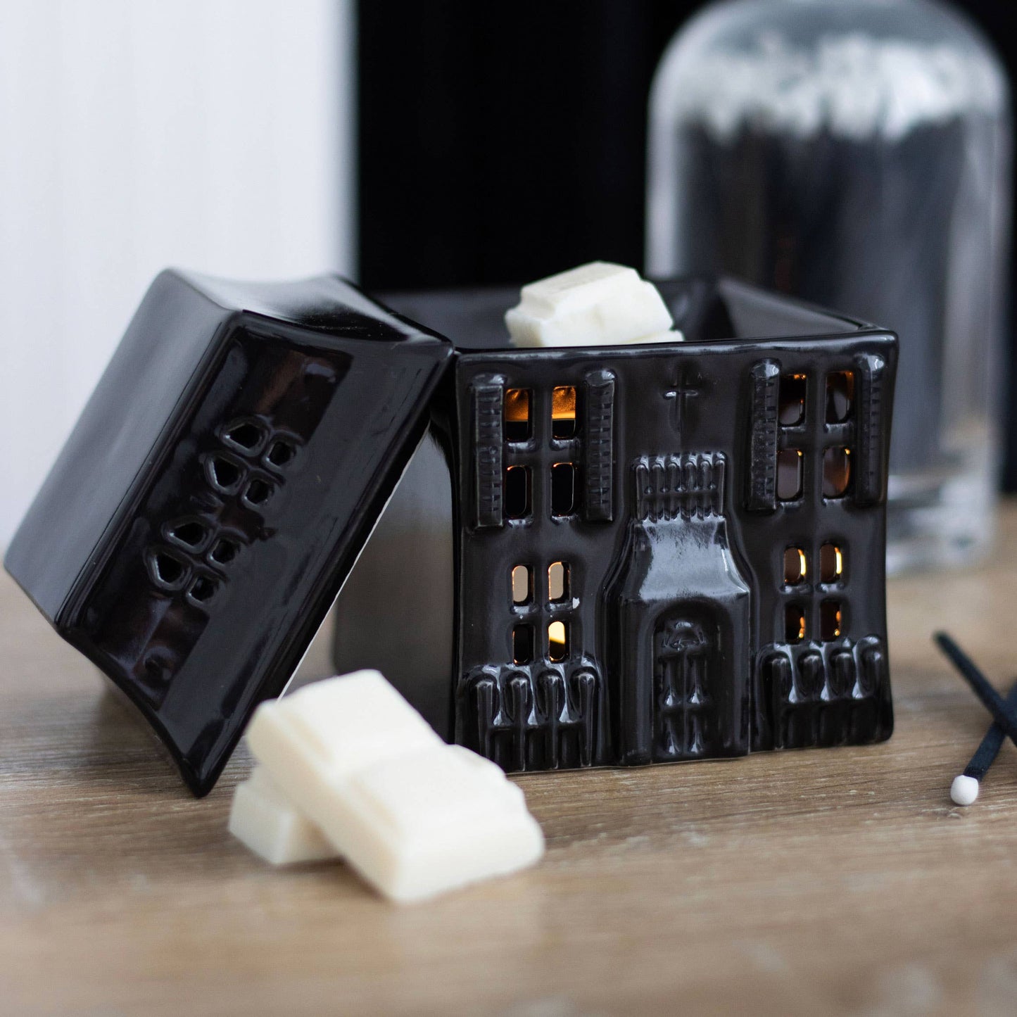 Ceramic black gothic house wax or oil burner. Lid off with wax melts in front of it