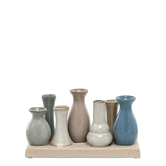 Set of ceramic vases on a wooden stand against a white background