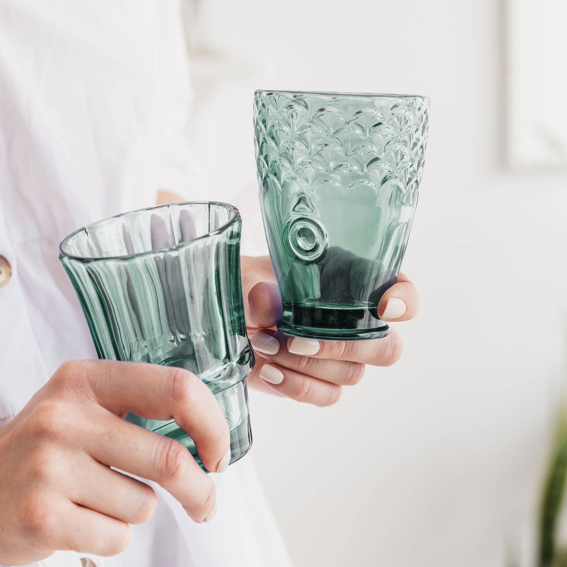 Person holding a glass in their hand 