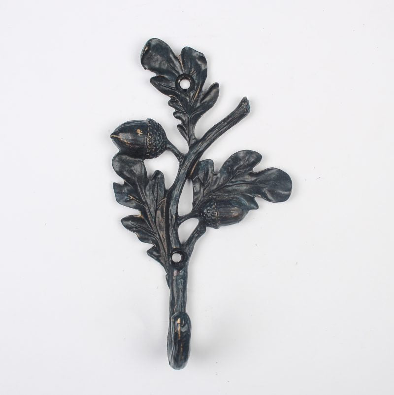Decorative metal wall hook with floral design on a white background
