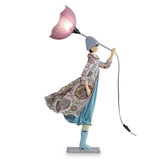Decorative lamp shaped like a person holding a pink umbrella on a white background