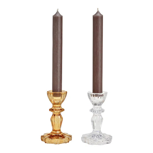 Two candlesticks with candles on a white background