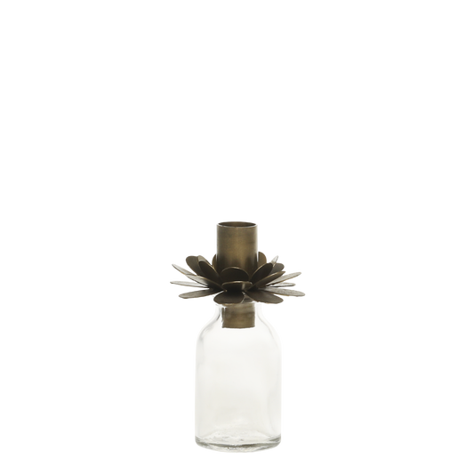 Clear glass bottle with a decorative metal cap on a white background