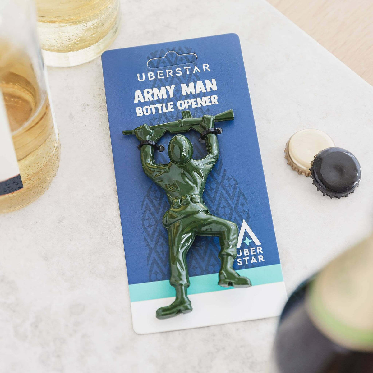 Army Man bottle opener on a card with a glass of beer and bottle cap in the background.