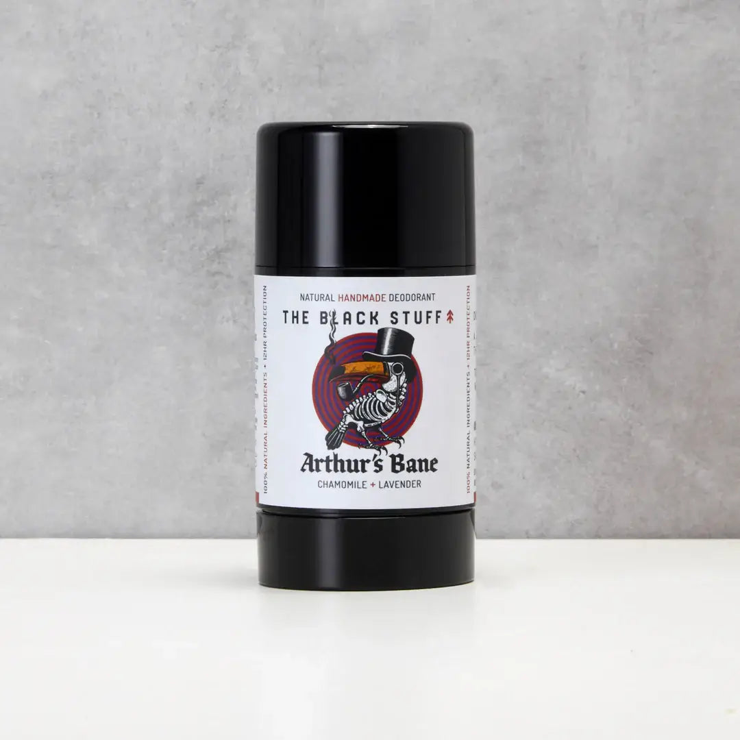 Deodorant stick labeled 'The Black Stuff' by 'Arthur's Bane' on a gray background