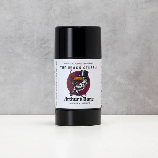 Deodorant stick labeled 'The Black Stuff' by 'Arthur's Bane' on a gray background